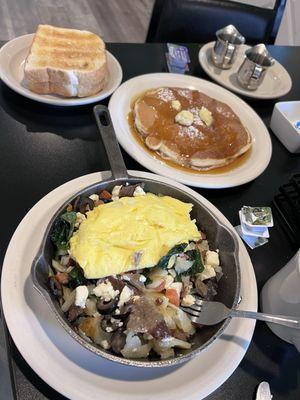 Mediterranean skillet with side pancake and toast.