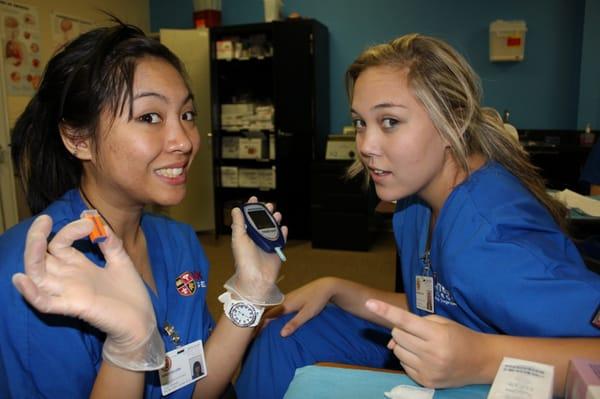 MA students measure blood glucose during lab.