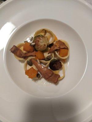 Housemade goat chesse ricotta cappelletti with pumpkin puree, wild chantarelles, pepitas crumple and parmesan emulsion sauce