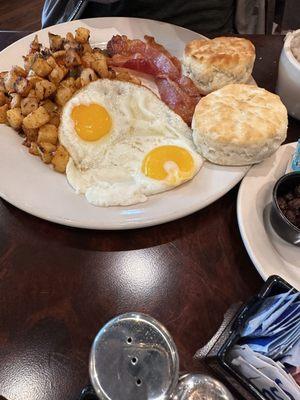 Eggs, biscuits, home fries, bacon