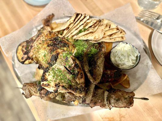 Poikilia Kreaton - chicken, lamb chops, sausage, pork skewers, fries, pita bread with tzatziki and a spicy whipped feta