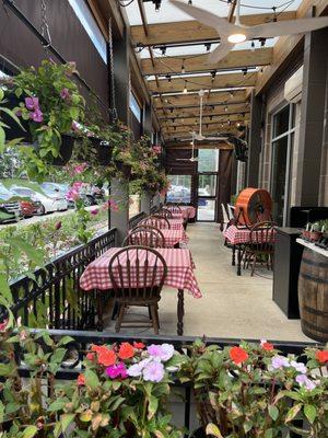 Such a cute patio, surrounded by hanging plants!  (6/18/2022)