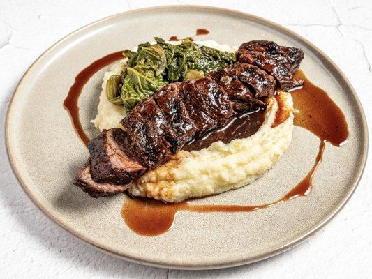 Bavette w/
Potato Mash Garlic Confit, Mustard Greens, Red Wine Jus