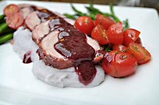 Bacon Wrapped Roasted Pork Tenderloin over Purple Mashed Potatoes with Raspberry Chipotle Glaze