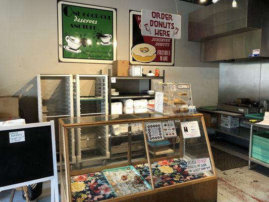 Donut counter. Display case and donut robot machine in back right.