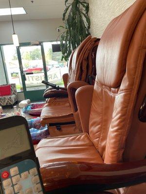 Massage chairs that look new, and there's no plastic covering the remotes.