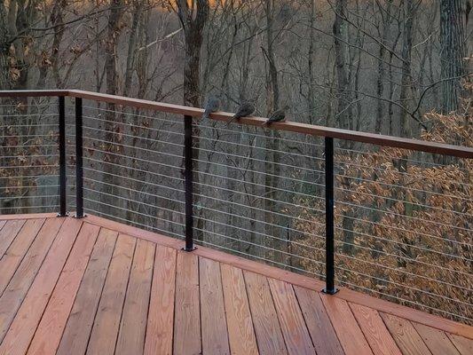 Handrails for decks look smart when matched with the deck flooring. This beautiful modern railing idea provides a unique deck railing style.