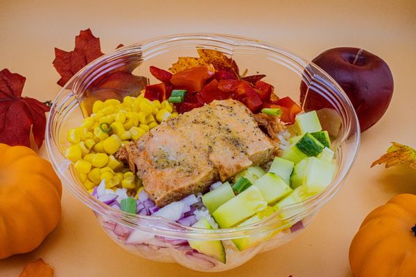 Honey glazed salmon power bowl. Honey glazed salmon over rice with corn, red bell peppers, red onions and cucumbers