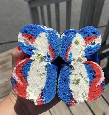 Red white and blue bagel with scallion cream cheese