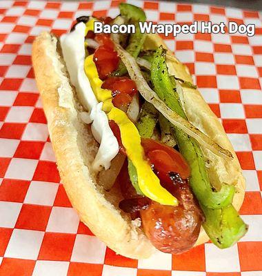 Bacon wrapped Hot Dog with peppers and onions, mayo, ketchup and mustard.