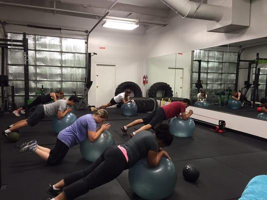 3Fit class working on core stabilization. Core is necessary to move safely. That's why we build core work into all of our classes