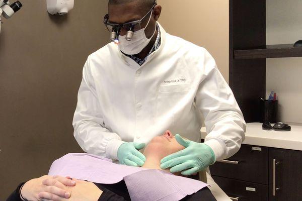 Dr. Cook performs an oral cancer screening on each patient at every exam