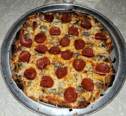 Large pepperoni, sausage and mushroom pizza