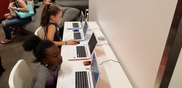 Kids at work on the computer.