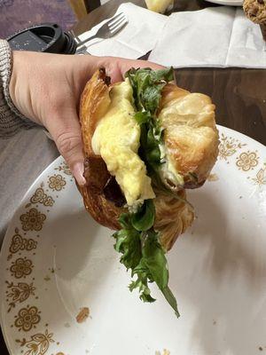 Their incredible build your own breakfast sandwich - basil aioli, egg, bacon, greens on a toasted croissant