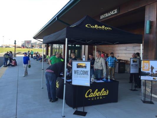 People are already in line for tomorrow's grand opening on the left.