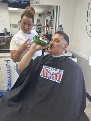 Enjoying his free drink during his cut, and there's his awesome barber Tree