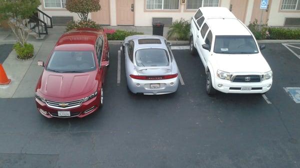 The housekeeping staff made me park my car so it stuck out really far into the driveway, because he claimed I was killing the bush.(Red Car)