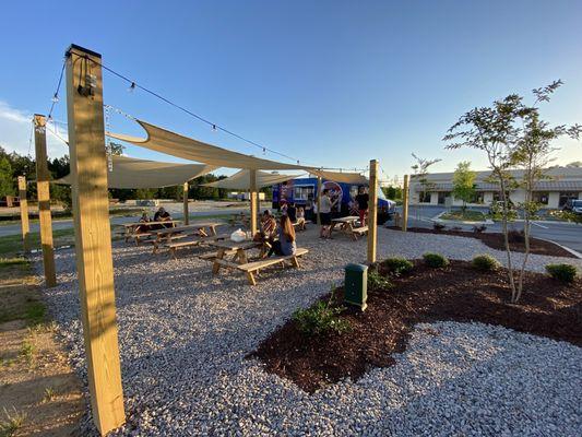 Here's a look at our exterior area! We feature six picnic tables, so you can enjoy your food truck meals comfortably during the summer!