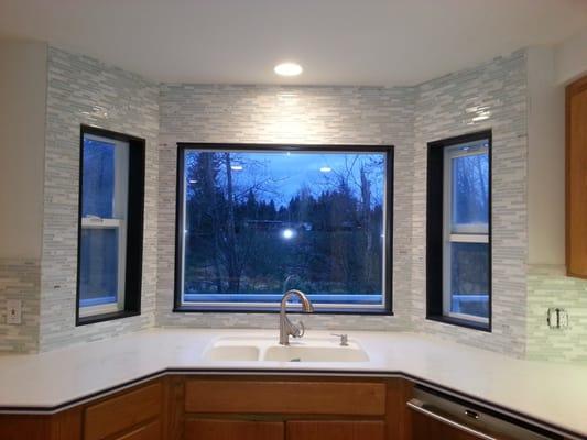 Mosaic glass tile backsplash with slate stone window casing.