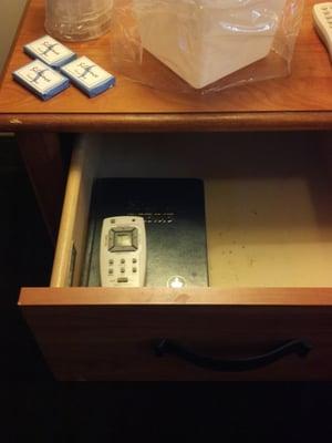 Nightstand drawer has Bible & remote control for air conditioning