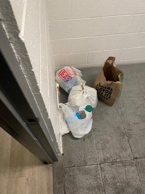 trash and a trail of ants into the hallway