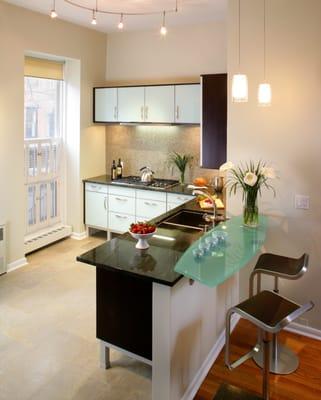 Client kitchen with all glass back painted doors in sea foam green.