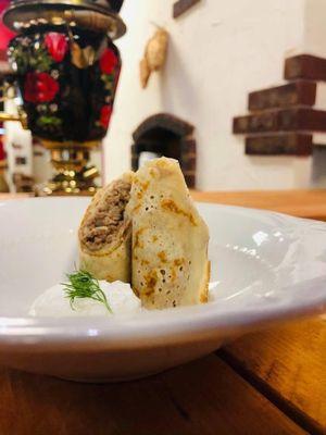 Blintzes.  Crape traditionally stuffed  with beef or red caviar.