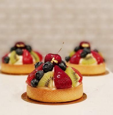 Fruit Tarts. Sweet shell filled with lychee cream and topped with fresh seasonal fruits.