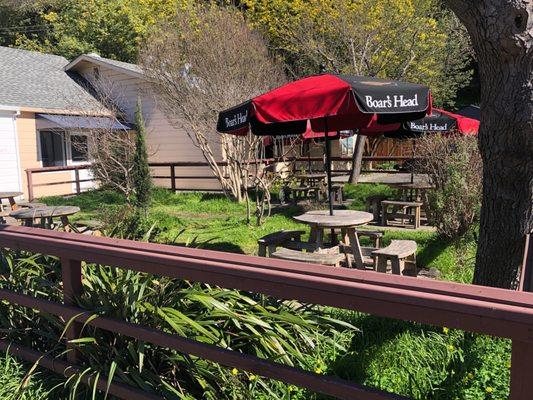 Outdoor patio seating area with tables and umbrellas