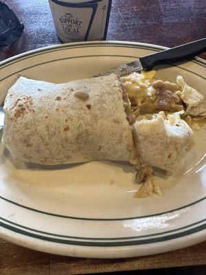 CHILAQUILES BURRITO Scrambled eggs, salsa verde, corn chips, cilantro, onions, anejo cheese and sour cream. Add rice & beans.