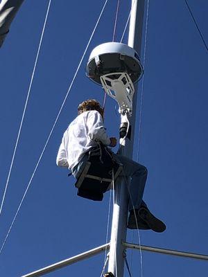 Simon up on the mast with new radar and radar mount