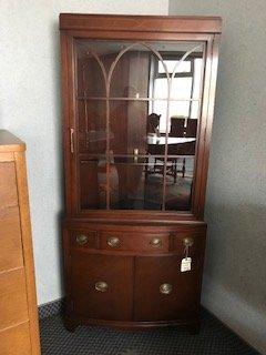 Mahogany corner cabinet. Have bought some beautiful pieces here. Quality workmanship. Highly recommend.