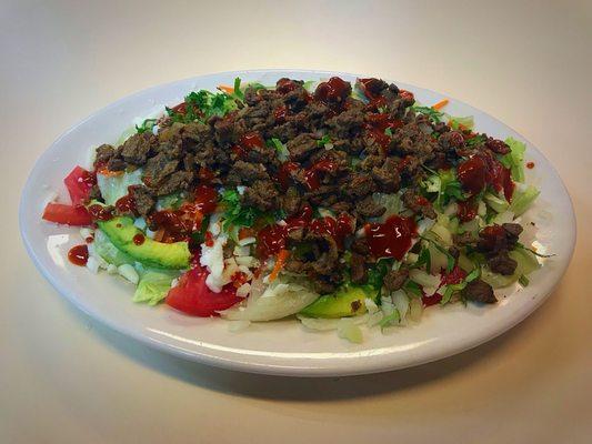 $12.30 for a house salad topped with 3 tacos worth of beef, onion and cilantro.