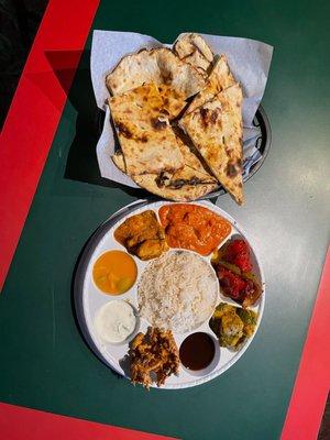 Lunch chicken sampler -  one with butter chicken, Tikka Masada chicken and curry chicken, a s 3 sides, rice, Naan AND dessert (gulab jamun)