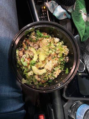 Small bowl, 1 scoop of salmon, nori strips, furikake, seaweed salad, garlic chips, cucumbers, cilantro, and green onions.