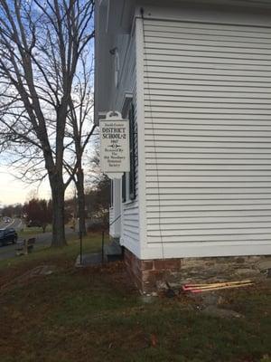 The old schoolhouse next to the Mason's sign - est. 1867