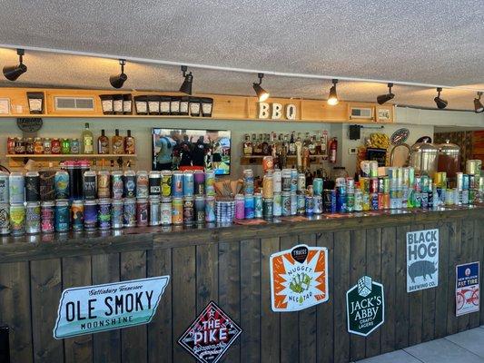 Extensive selection of craft beer cans, moonshine and bourbon whiskey.