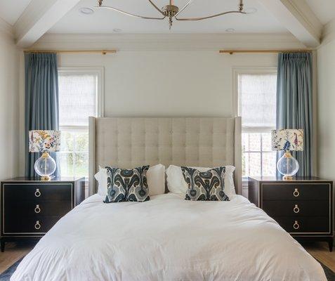 Layering roman shades with drapery in this Nashville, TN customer's primary bedroom adds depth and style, enhancing the room's overall look.