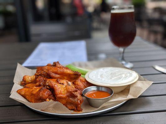 Buffalo wings with extra Buffalo sauce and a generous amount of blue cheese.