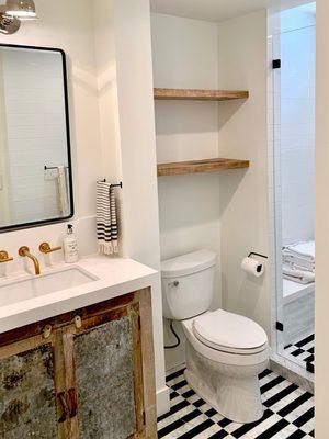 Circle Sawn Reclaimed Wood Floating Shelves in a small-spaced restroom