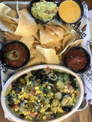 Burrito bowl, with two different salsa, chips, guacamole and queso for about $10.