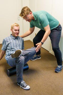 Dr. Joe Bell DC demonstrating self-care exercises for a patient