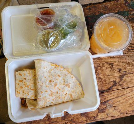 Quesadilla al pastor with three of the available sauces and a mango agua fresca.