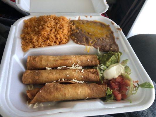 Chicken flautas with beans and rice. Real guacamole, cream and pick. Take out