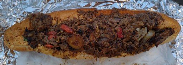 Cheesesteak sandwich with mushrooms, onions, red peppers, and wiz