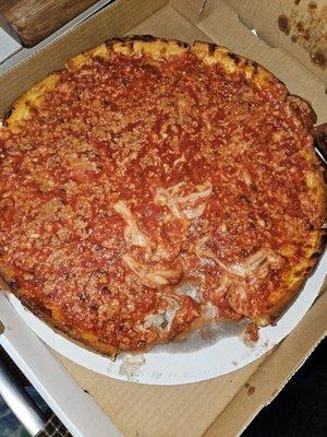 A deep dish pizza that is soggy and watery.  Therevis actually one piece of pizza missing from this pizza.