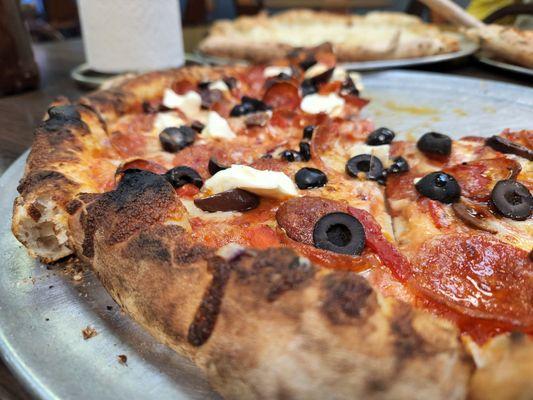 Double pepperoni, black olives, kalamata olives, cream cheese, roasted red peppers and onion