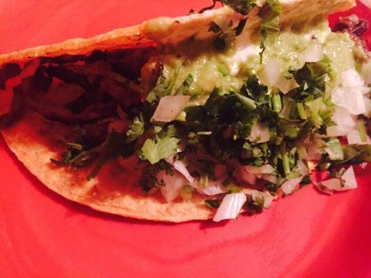 Carne Asado taco with sour cream and avocado