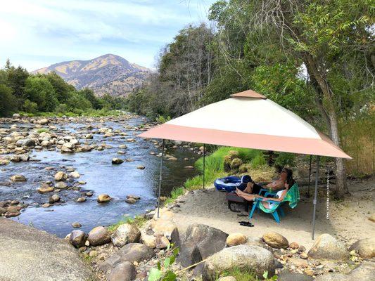 Guests relax in private river beach cabana at Rio Sierra Riverhouse